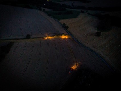 A combine harvester harvests a grain forest. When it is harvest time, the grain must also be