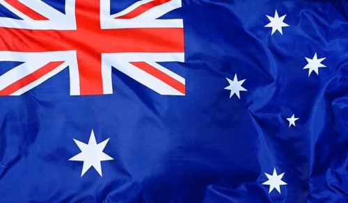 Close-up of the national flag of Australia, fluttering in the wind with folds, wave pattern
