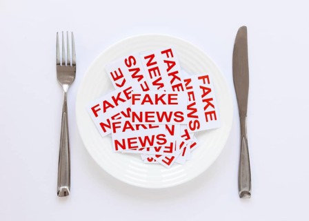 Plate with paper sheets with with fake news