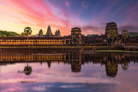 Panorama of Angkor Wat temple reflecting in water at sunset near Siem Reap, Cambodia, Asia