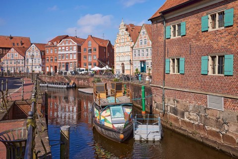 Harbour basin with railings, boats and the gabled houses, brick buildings and half-timbered houses
