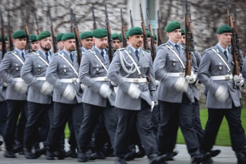 Army soldiers of the guard battalion march as part of an honour formation at the Chancellery in