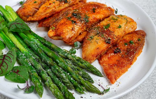 Fried fish fillet, tilapia with asparagus, homemade, no people