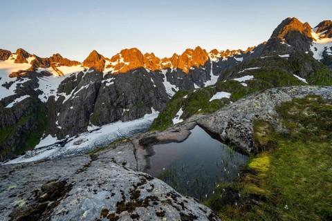 Rocky mountain peaks, small pond with cotton grass in moor landscape at Trollfjord Hytta, mountain