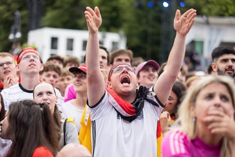 Football fans in the fan zone at the Brandenburg Tor during the quarter-final match between Germany