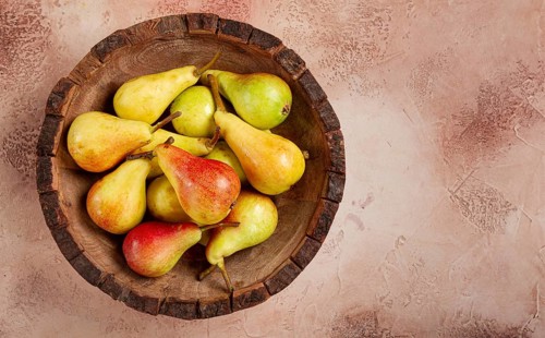 Pears, Duchess variety, small pears, early harvest, in a wooden plate, top view, no people