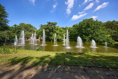 Fountain in a pond in Bochum municipal park, Ruhr district, independent city, North