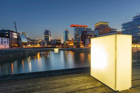 Illuminated pedestrian bridge over the harbour basin in the Media Harbour, Düsseldorf, North