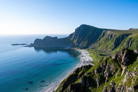View of coastal landscape, cliffs with peak Måtind or Måtinden, Høyvika beach and sea, hike to the