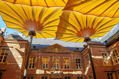 Court of honour covered by huge parasols at Commandery of Alden Biesen, 16th-century castle at