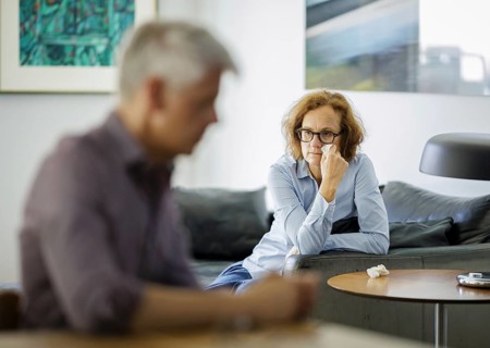 Symbolic photo on the subject of problems in a partnership. An older woman and an older man sitting