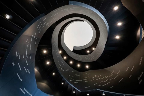 Spiral staircase printed with Finnish words, Oodi Central Library and Cultural Centre, designed by