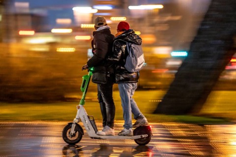 Young people riding in pairs on an e-scooter, Essen, North Rhine-Westphalia, Germany, Europe