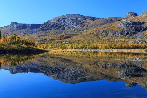 Mountains reflected in lake, autumn colours, sunny, bright, Stora Sjöfallet National Park, Laponia,