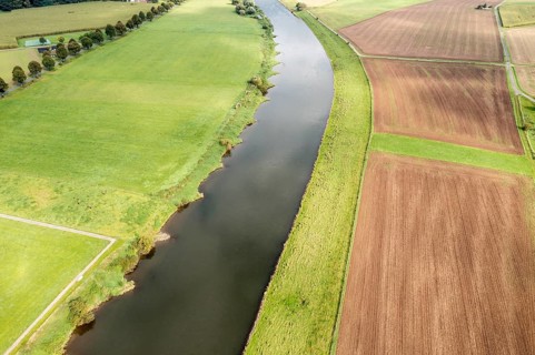 Aerial view over fields and meadows at the Weser river, east of village Wahmbeck, Weserbergland,