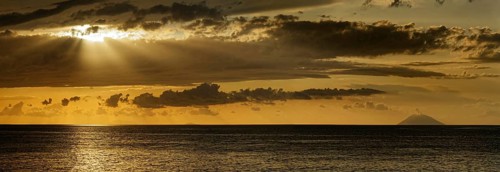 Sunset on the beach of Tropea with the Aeolian (Liparic) Islands and the volcanic island of