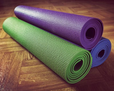 Vintage retro effect filtered hipster style image of Yoga mats on wooden floor