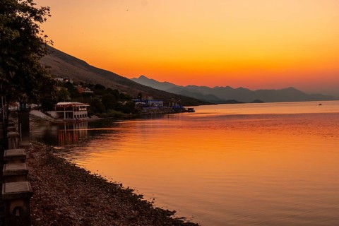 Beautiful orange summer sunset at Shkoder Lake in Shiroka Municipality. Albania