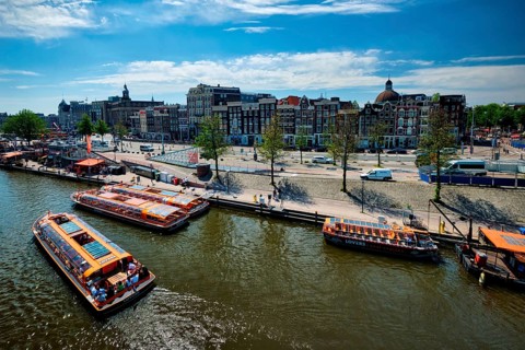 AMSTERDAM, NETHERLANDS, MAY 9, 2017: Aerial view of Amsterdam canal with tourist boats near