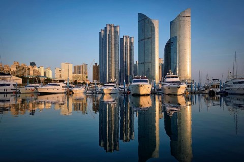 Busan marina with yachts, Marina city skyscrapers with reflection on sunset, South Korea, Asia