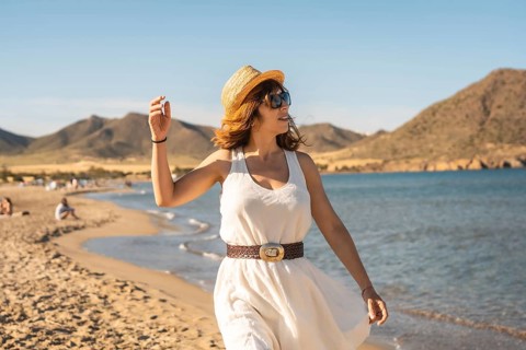 Woman enjoying alone walking along a beach in Cabo de Gata, Spain, Europe