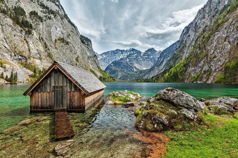 Boat dock hangar on Obersee mountain lake in Alps. Bavaria, Germany, Europe