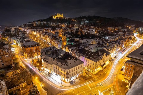 The lights of the snow-covered town of Marburg an der Lahn glow in the evening, Wetterau, Marburg,
