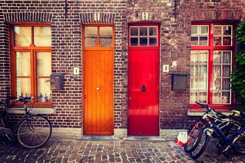 Doors of old houses and bicycles in european city. Bruges Brugge, Belgium, Europe