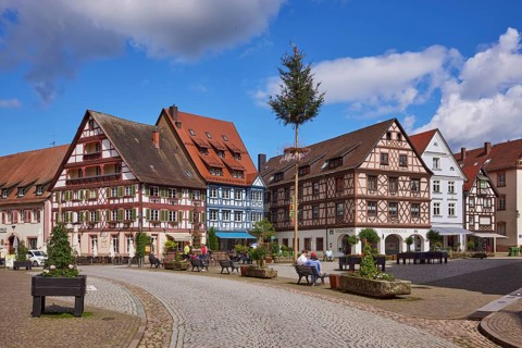 Market square with maypole, benches, flower tubs and half-timbered houses in Gengenbach, Black