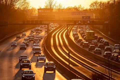 Motorway A40, dense, slow-moving traffic jam, evening traffic at the Essen-Kray junction, low sun,