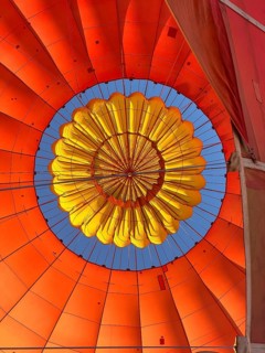 Hot air balloon inside view to the top middle, top opens to release warm air before landing. Hot