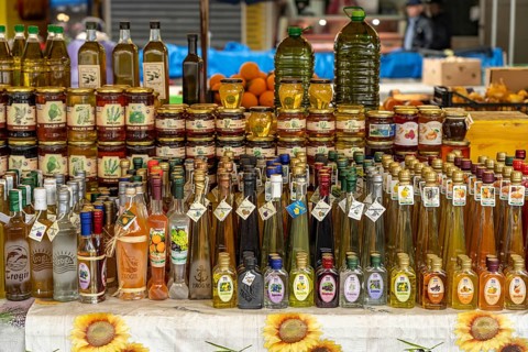 Liqueurs, schnapps, honey and olive oil at the market in Trogir, Croatia, Europe