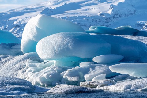 A large block of ice is surrounded by smaller pieces of ice, Jokulsarlon, Iceland, Europe