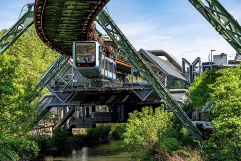 The Wuppertal suspension railway, train of the latest generation 15, floats above the Wupper,