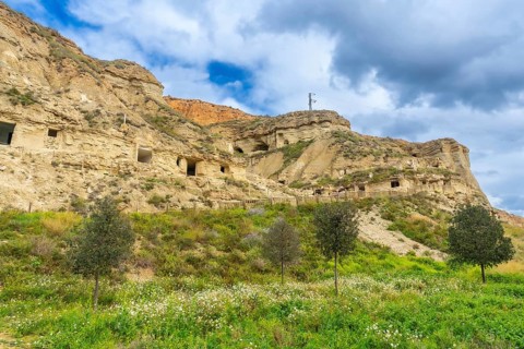 Scenic view of cuevas de arguedas, ancient cave dwellings carved into sandstone cliffs,