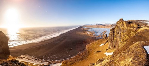 Panoramic view of Dyrholaey beach in cold winter with snow in Iceland, near Vik