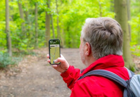 Symbolic image Hiking with smartphone and hiking app, navigation on hiking trails, digital hiking