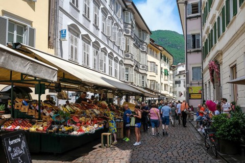 Bolzano, South Tyrol, Italy, Passers-by stroll through the fruit market on Obstplatz square in the