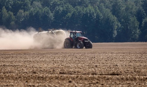 Upper Lusatia, Saxony, Germany - Dust-dry fields in a hot summer, a tractor working the field,