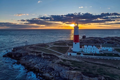 Sunset over Portland Bill Lighthouse from a drone, Portland Bill, Isle of Portland, Dorset,