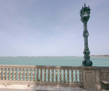 View over the bay of Cadiz with lamppost from the garden Jardines Clara Campoamor, Cádiz, Spain,