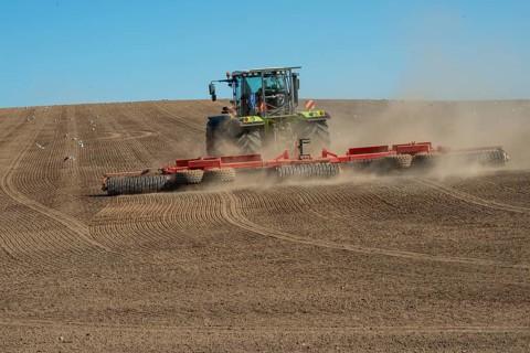 Tractor with rollers preparing the ground for spring sowing at Krageholm, Ystad Municipality, Skåne