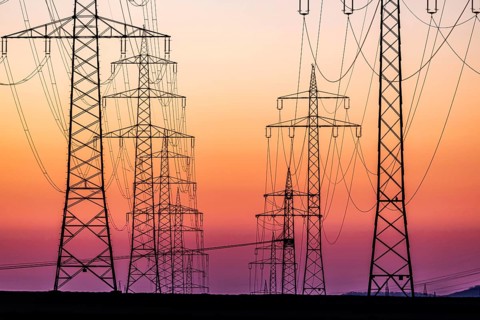 High-voltage pylons, overhead power lines at sunset. Schwieberdingen, Baden-Württemberg, Germany,