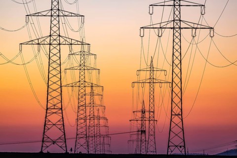 High-voltage pylons, overhead power lines at sunset. Schwieberdingen, Baden-Württemberg, Germany,