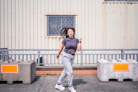 Modern young beauty woman dancing k-pop korean dance in the city