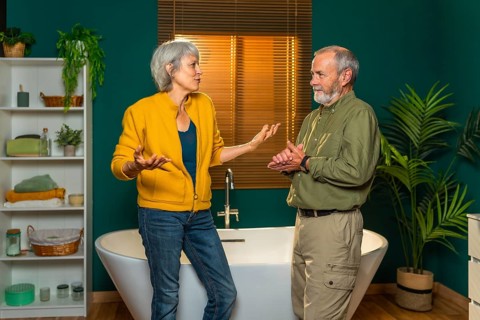 Casual caucasian senior couple discussing and talking standing together in the bathroom
