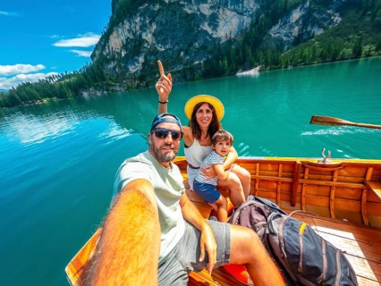Family taking a selfie while enjoying a boat trip on the beautiful lake braies, surrounded by the