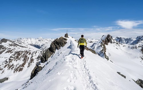 Mountaineer on the summit of the Scalettahorn in winter, Graubünden Haute Route, Albula Alps,