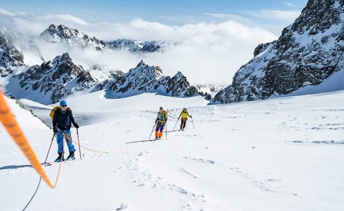 Ski tourer with rope, rope team on the Vadret da Porchabella glacier on the ascent to the summit of