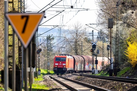 Goods train with a Deutsche Bahn AG locomotive travelling on the open track. Stuttgart,